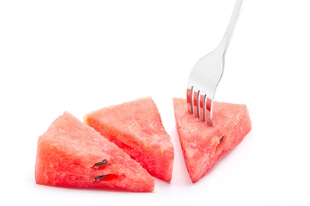 Pieces of watermelon with fork isolated on white background.の写真素材