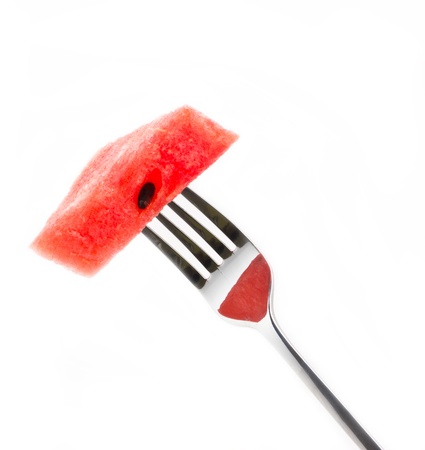 Piece of watermelon with fork isolated on white background.の写真素材