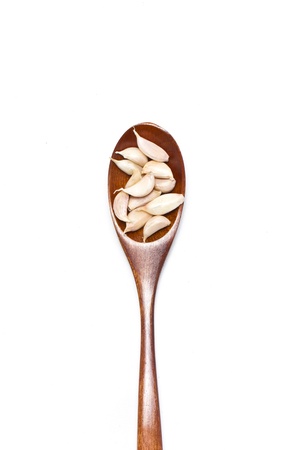 Garlic with wooden spoon isolated on white background.の写真素材