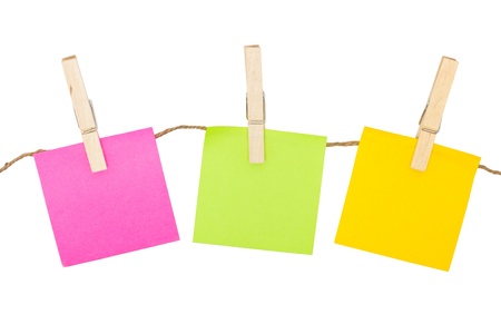 Colorful sticky notes with clothespins isolated on white background の写真素材