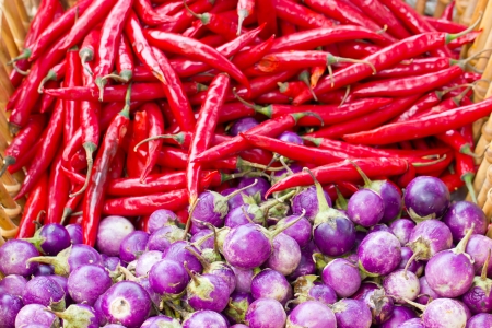Heap of purple eggplant and red chili.の写真素材