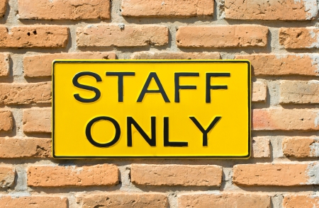 staff only sign on brick wall.の写真素材