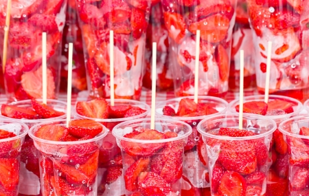Fresh strawberry in transparent plastic glasses 