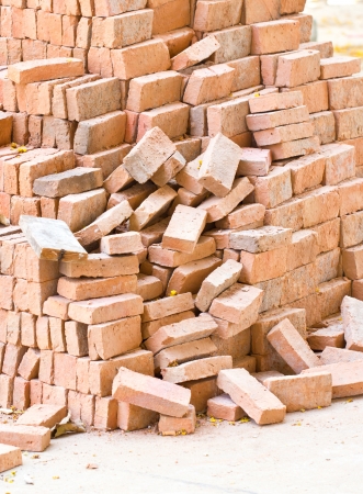 Pile of red bricks at construction site の写真素材