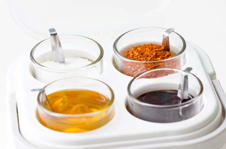 Thai seasoning container include cayenne pepper, sugar, fish sauce and chilies in vinegar の写真素材