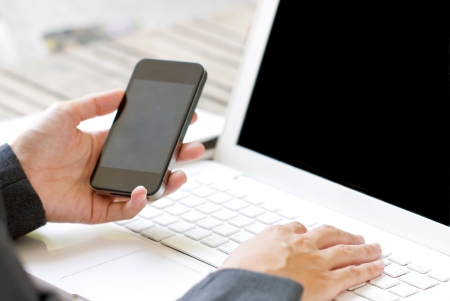 Smartphone in business womanの写真素材