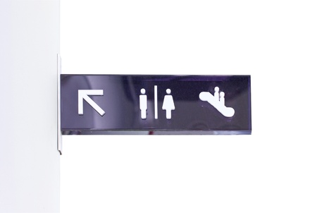 Dirty arrow signs to toilet and escalator の写真素材