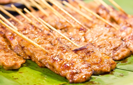 Thai style BBQ pork on banana leaf の写真素材