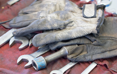 Dirty Gloves And Wrenches On Mechanic's Tableの写真素材