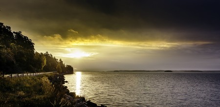 Vibrant colors over the sea as the morning sun rises in the north of Sweden