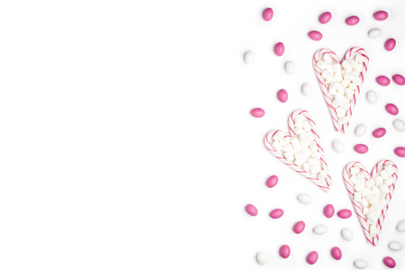 Frame Pink and White candies and lollipops in the form of heart with Marshmallow Top view White Background Valentine's Day Christmas New Yearの写真素材