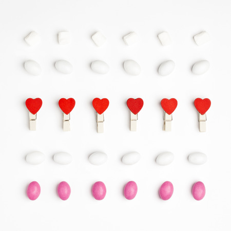 Pattern Marshmallow, White and Pink Candies and Clothespin with red hearts Top view White Background Valentine's Day romanticの写真素材