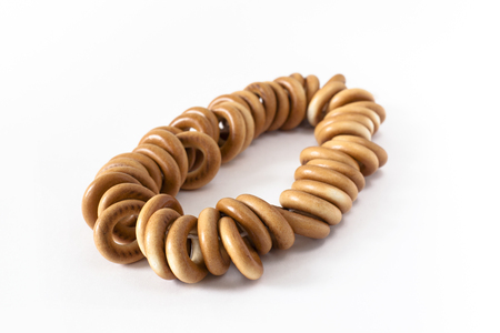Bagels on rope, isolated on white backgroundの写真素材