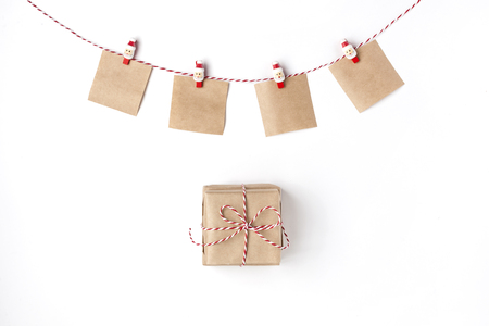 Gift, candles, notes with wish on clothespins, Top view White Background Christmas New Yearの写真素材