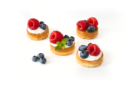 Belgian waffles with blueberry, raspberries and fresh mint on white backgroundの写真素材