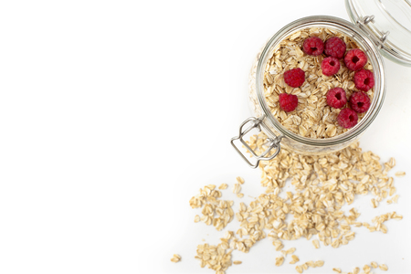 Breakfast of oatmeal with berries in a jar on white backgroundの写真素材
