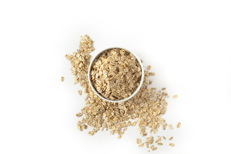 Oatmeal in the cup on white backgroundの写真素材