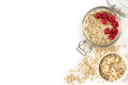 Breakfast of oatmeal with berries in a jar on white backgroundの写真素材
