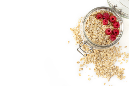 Breakfast of oatmeal with berries in a jar on white backgroundの写真素材