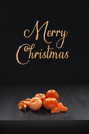 Christmas composition. Mandarins, tangerine slices, tangerine peel on black background. Christmas, winter, new year, halloween concept.の写真素材