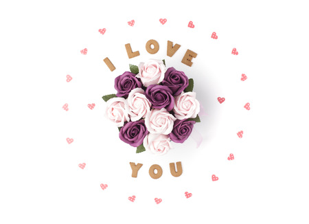 Valentine's day concept. Declaration of love, frame made of paper hearts. In the center flowers in a box. Flat lay, top view, white background, isolated, copy spaceの写真素材