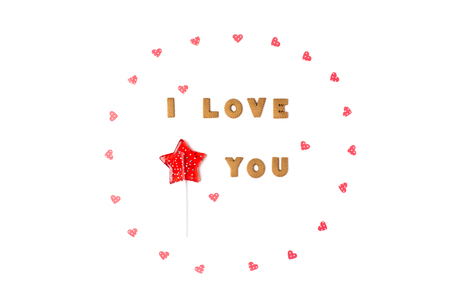 Valentine's day concept. Declaration of love, frame made of paper hearts, lollipop in form star. Flat lay, top view, white background, isolated, copy spaceの写真素材