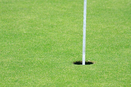 Golf Hole on green with flag in cupの写真素材