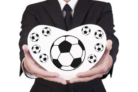 Businessman holding paper show football in hand の写真素材