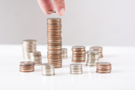 Person top up coin on the highest heapの写真素材