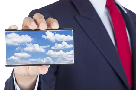 showing smartphone on businessman hand with cloud computing technology on screen isolated on white backgroundの写真素材