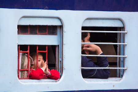 DELHI, INDIA - FEBRUARY 23: Indian people waiting for train moving out from  train station on February 23, 2013 in Delhi, India. Indian railways transport 20 million passengers daily.のeditorial素材