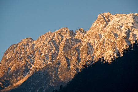 Crop view mountain peak warm color by sunlight in the morningの写真素材