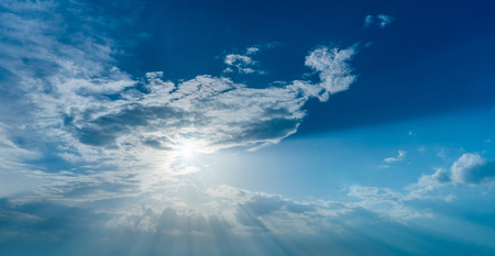 Sun rays through clouds like an dramatic explosion , power nature background.