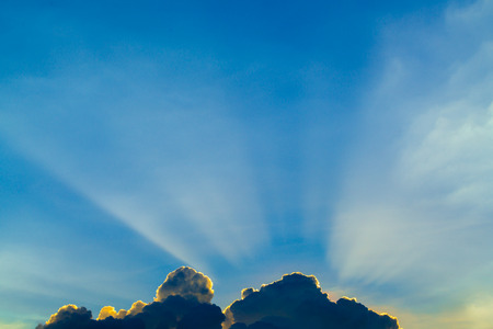 Sun rays through clouds like an dramatic explosion , power nature background.