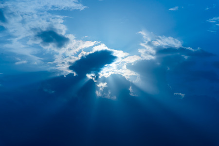 Sun rays through clouds like an dramatic explosion , power nature background.