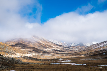 Mist and cloud cover mountain peak Landscape view at ZERO POINT, blue sky day time, Sikkim,Indiaの写真素材