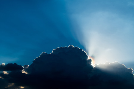 Sun rays through clouds like an dramatic explosion , power nature background.の写真素材
