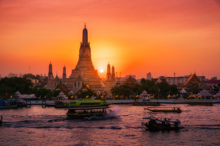 Sunset at Arun Temple or Wat Arun, locate at along the Chao Phraya river with a colorful sky in...