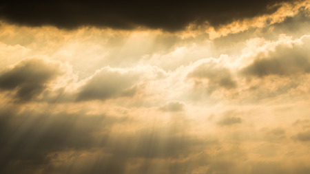 Sun rays through clouds like an dramatic explosion , power nature background.