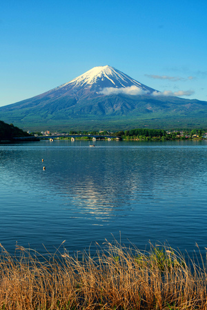 Fuji mountain and Kawaguchiko lake in morning, fog flow on the air.の写真素材