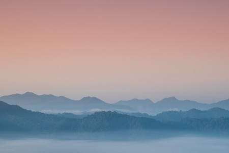Foggy and mountain on edge range with copy-space on skyの写真素材