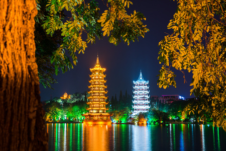 Night view of the Sun and Moon Pagodas at Shanhu Lake or Fir Lake. Gold and Silver Pagodas locate at downtown of Guilin, China. Guilin is a popular tourist destination of Asia.の写真素材