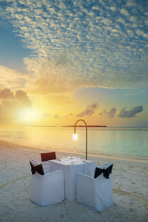 Table outdoor next to sea scenic prepare for special romantic dinner time with sunlight shadingの写真素材