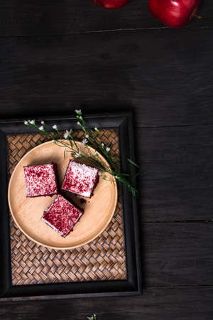 cake in the wood dish lay on black wood table