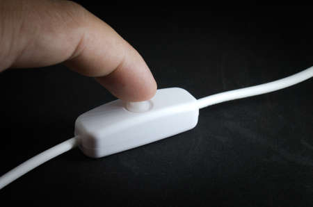Finger turning on / off  the switch of lightの写真素材