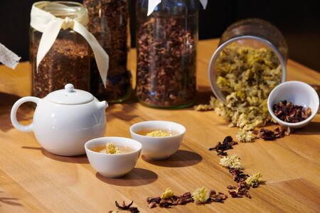 Chrysanthemum tea in Chinese teapot cups; focus on teaの写真素材