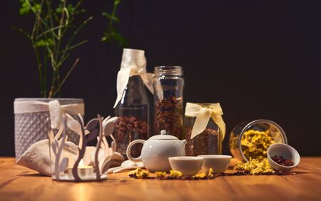Chrysanthemum tea in Chinese teapot cups; focus only on teapot