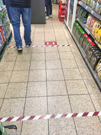 Darmstadt, Germany, Mar 28 2020: Sign on the floor of the supermarket to keep the necessary distances due to the virus coronaのeditorial素材