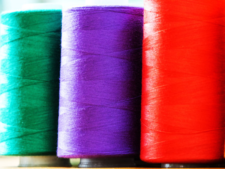 Close-up of multi-coloured sewing threads background.