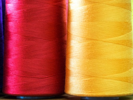Close-up sewing threads multicolored background.